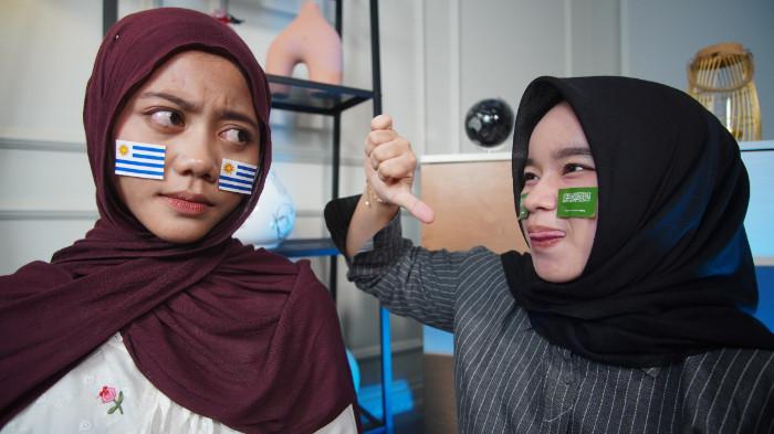 Dua wanita mengenakan striker Uruguay dan Arab Saudi di wajah sebagai bentuk dukungan pada Piala Dunia 2026, di Kota Solo, Jawa Tengah, Senin (15/6/2026). (Tribun-Video.com/Akmal Khoirul Habib)