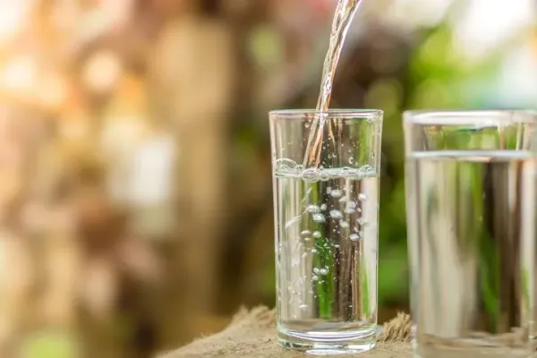 Young woman drinking pure glass of water