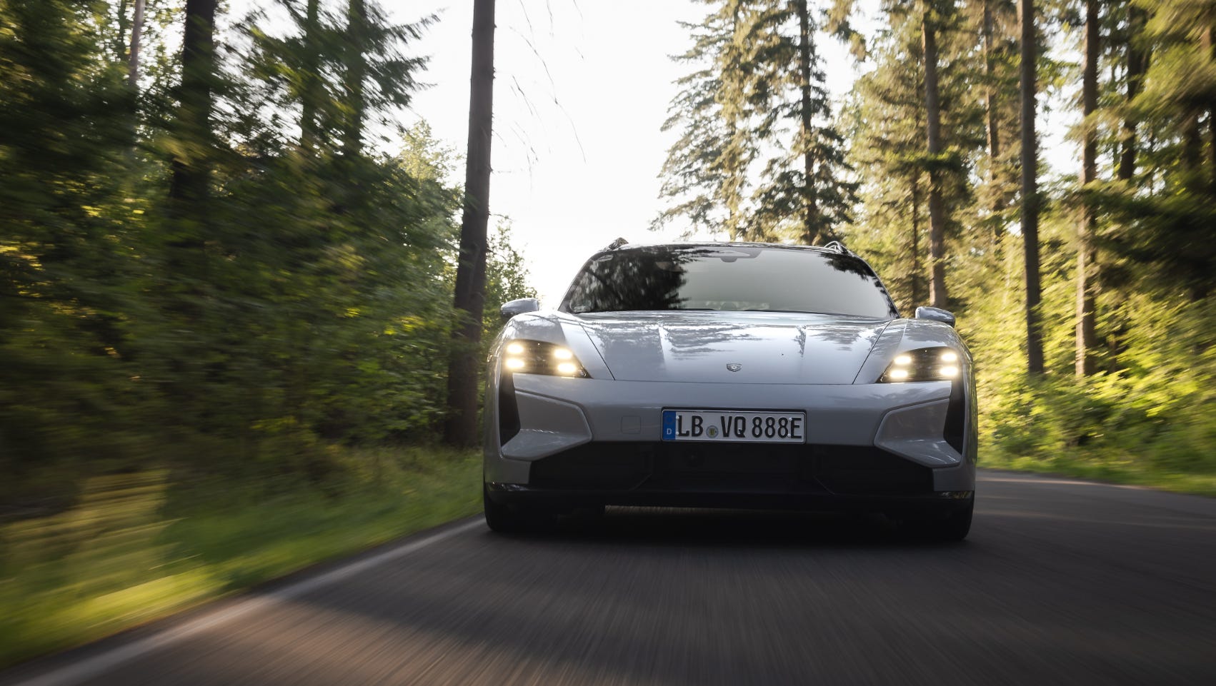 electric car driving on a forest road