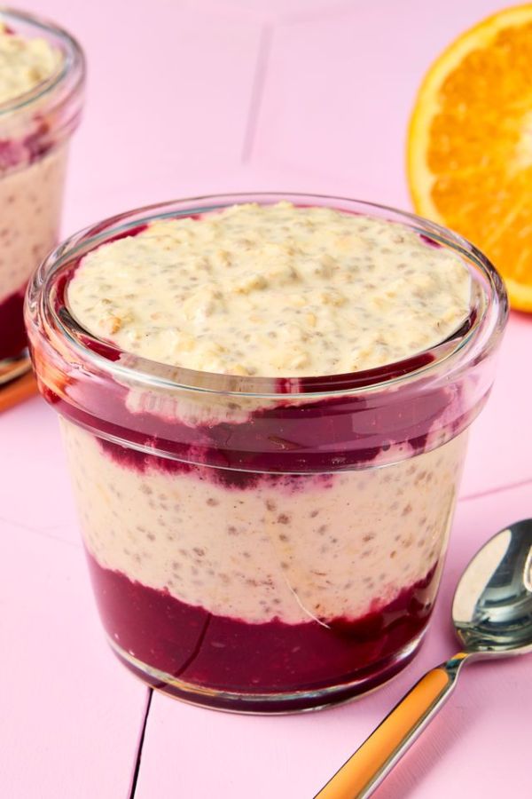 A jar of cranberry orange overnight oats displayed with a peachcolored background and a partial view of an orange slice Credit: Photographer: Robby Lozano, Food Stylist: Isabelle Easter, Prop Stylist: Keoshia McGhee