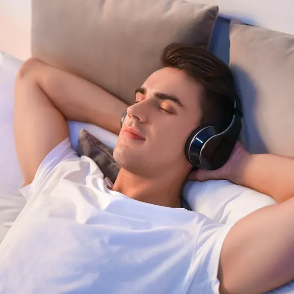 man listening to nature sounds before sleep