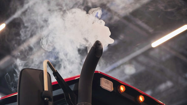 Truck exhaust showing white smoke in enclosed environment