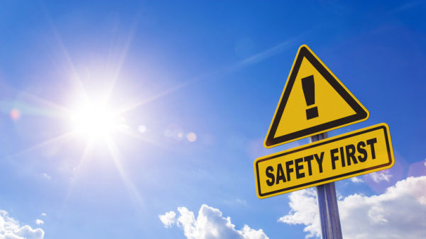 A yellow warning sign with an exclamation mark and 'safety first' written