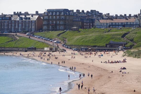 People on Tynemouth Beach in the North East of England. Heatwave conditions are forecast for parts of the UK this weekend as tem People on Tynemouth Beach in the North East of England. Heatwave conditions are forecast for parts of the UK this weekend as tem