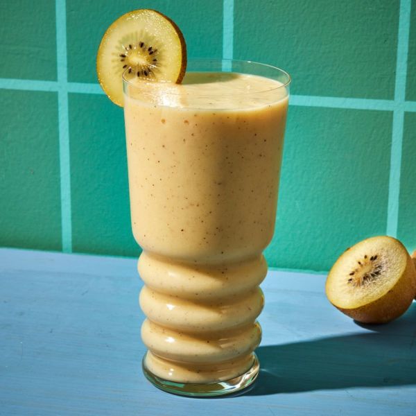 a photo of the Tropical Smoothie garnished with a kiwi slice Credit: Photographer: Jen Causey, Food Stylist: Jennifer Wendorf, Prop Stylist: Christina Brockman