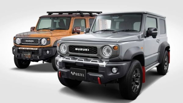 Two Suzuki off-road SUVs, one silver with red mud flaps and one orange with a roof rack, shown front-side view.