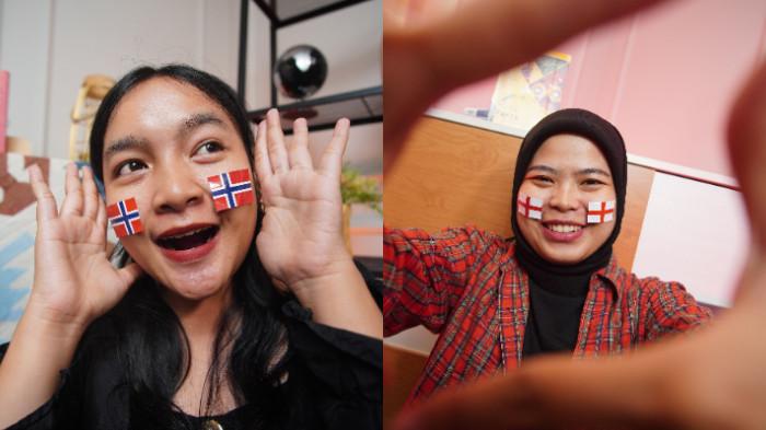 Dua wanita menggunakan stiker bendera Norwegia dan Inggris di wajah sebagai bentuk dukungan dalam Piala Dunia 2026, di Kota Solo, Jawa Tengah, Senin (16/6/2026).