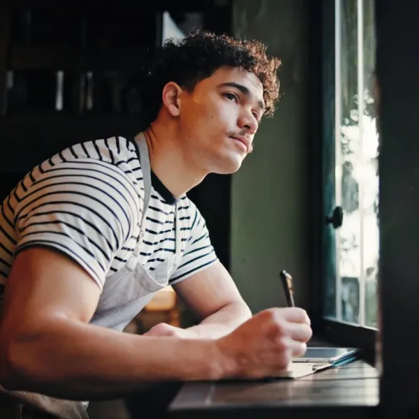 man with a journaling hobby that doesn't feel like therapy but is good for his mental health
