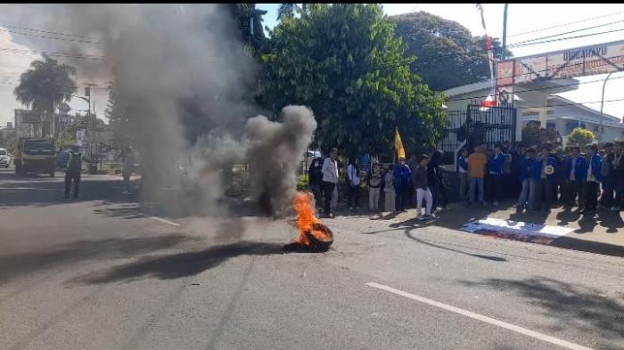 Massa Pergerakan Mahasiswa Islam Indonesia (PMII) Cabang Mamuju menggelar aksi demonstrasi di depan Gedung DPRD Kabupaten Mamuju, Selasa (14/7/2026). Dalam aksi tersebut, massa membakar ban bekas, menyampaikan orasi, dan menyerahkan 12 tuntutan kepada Pemerintah Kabupaten Mamuju dan DPRD.