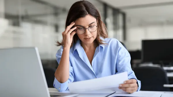 woman not in the mood to do work sitting at desk