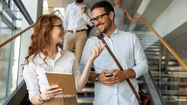 woman talking to co-worker saying her work will get done eventually
