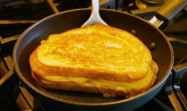 Picture of someone cooking a cheese toastie Picture of someone cooking a cheese toastie
