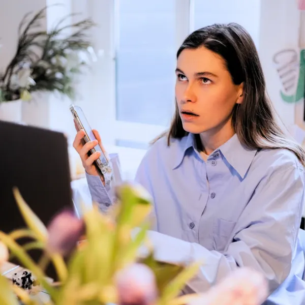 Annoyed woman saying "everyone's just jealous of me" on the phone.