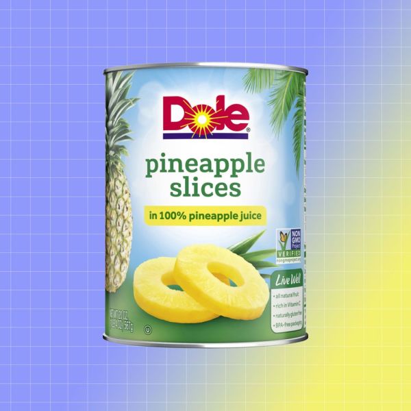 A can of Dole pineapple slices displayed against a colorful background labeled as being in 100 pineapple juice Credit: Dollar General. EatingWell design.