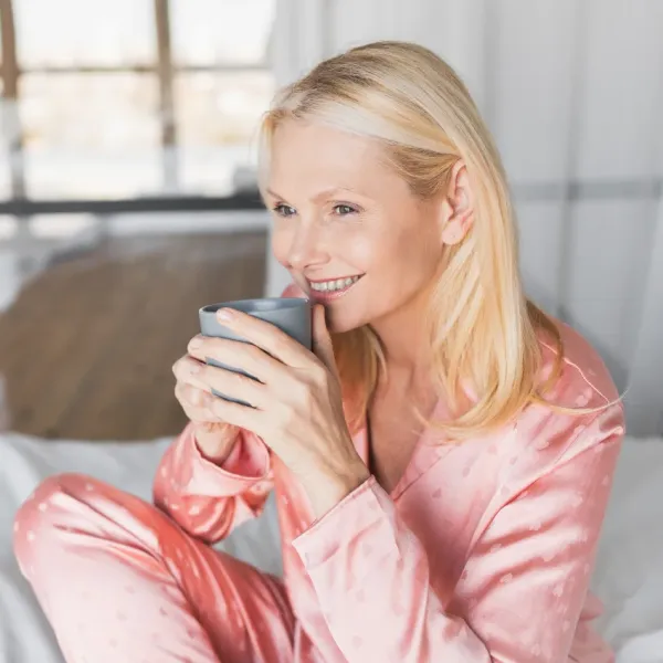 woman enjoying lazy morning in bed treats her weekends like a vacation
