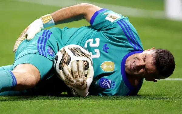 Argentina goalkeeper Emiliano Martinez tries to buy time by laying down on the pitch at the end of the match against England. Photo by Reuters