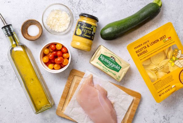 Ingredients for a quick dinner including chicken breast zucchini ricotta ravioli cherry tomatoes lemon pesto and olive oil Credit: Abbey Littlejohn