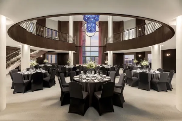 Altitude 23 is a double-height circular atrium extending across two levels, with a sculptural chandelier suspended through the central opening. Photo courtesy of the hotel