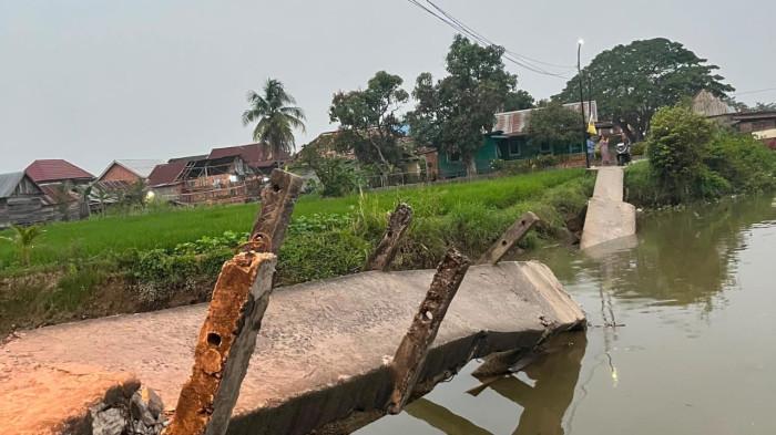 JEMBATAN AMBRUK – Kondisi jembatan akses utama warga di Jalan Kemas Rindo (Sungki), RT 43, Kelurahan Ogan Baru, Kecamatan Kertapati, Palembang, yang ambruk pada Rabu (22/7/2026). Putusnya jembatan menghambat aktivitas masyarakat dan pelajar yang selama ini bergantung pada jalur tersebut.