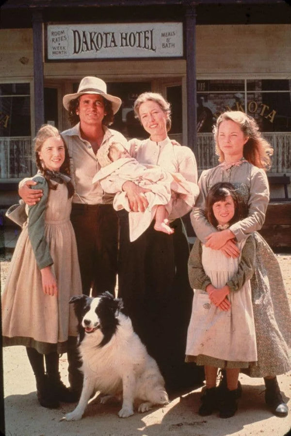 The cast of the television series 'Little House on the Prairie' with a dog on the set of the show, mid 1970s. Clockwise from left: American actors Melissa Gilbert, Michael Landon (1936 - 1991), Karen Grassle, who holds an unidentified baby, Melissa Sue Anderson, and Lindsay or Sidney Greenbush.