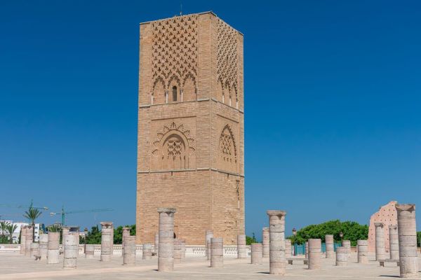 The historic Hassan Tower stands majestically next to the columns of the ancient, unfinished mosque in Rabat, Morocco. The historic Hassan Tower stands majestically next to the columns of the ancient, unfinished mosque in Rabat, Morocco.