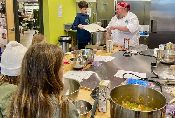 A chef wearing a red bandana teaching children during a cooking class Credit: Willy Street Food Co-op.