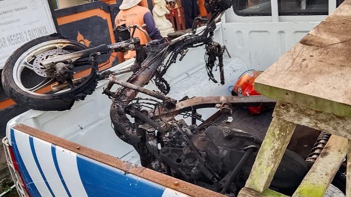 MENGAMANKAN - Aparat kepolisian Polsek Baturiti saat mengamankan kendaraan pelaku usai dibakar warga pada Sabtu 25 Juli 2026