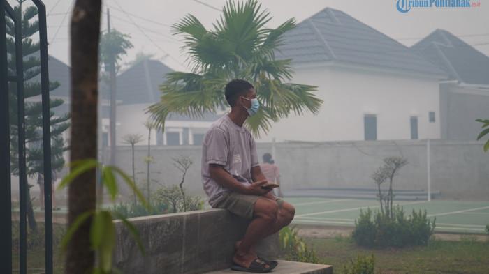 KUALITAS UDARA KALBAR - Warga Kompleks Taman Bumi Serdam, Jalan Sungai Raya Dalam, Kabupaten Kubu Raya terpaksa mengenakan masker imbas Karhutla pada Sabtu 25 Juli 2026. BMKG Kalbar mengungkap kualitas udara Kabupaten Kubu Raya dan Mempawah kategori sangat tidak sehat.