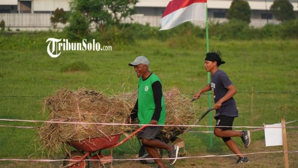EVENT KLATEN - Petani peserta Balap Angkong Race memacu gerobak berisi jerami di lintasan persawahan saat Festival Prei Sekolah 2026 di Desa Kemudo, Kecamatan Prambanan, Klaten, Minggu (5/7/2026).