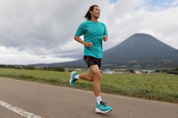 Person running on a path outdoors with a mountain in the background wearing athletic clothing and shoes Credit: Amazon