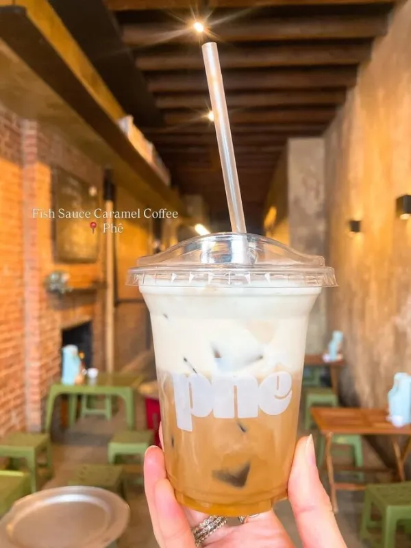 The fish sauce caramel latte is served in separate layers, with coffee beneath a layer of milk. Photo courtesy of Instagram/dishingdaily