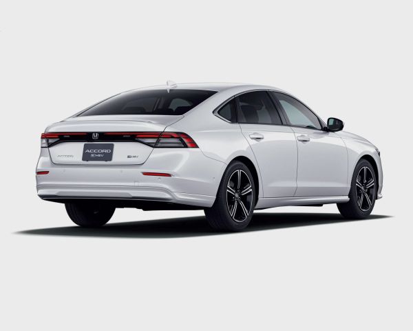 White Honda Accord e:HEV hybrid sedan rear view with black alloy wheels on a white background.