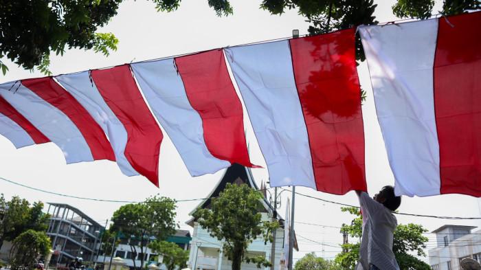 PENJUAL BENDERA-Dedi penjual bendera di trotoar Jalan Khatib Sulaiman, Kota Padang, Sumatra Barat, Minggu (2/8/2026) siang. Ia sedang merapikan dagangannya sembari menunggu pembeli.(doc: Arif RK)