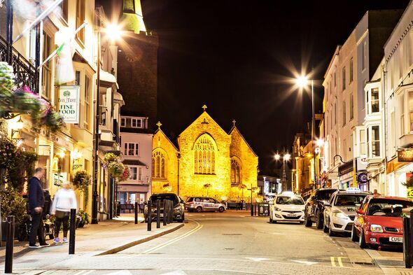 view of St Mary's Church at night from St Julian's St, Tenby, UK