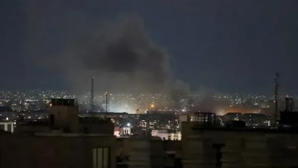 A plume of smoke rises from the site of a strike in Tehran early on March 28, 2026. Israel and the United States launched strikes on Iran on February 28, killing the Islamic republic's supreme leader and sparking a war that has since spread across the Middle East. (Photo by ATTA KENARE / AFP) /