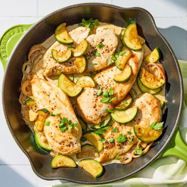 A recipe image of Creamy Garlic Chicken & Zucchini Skillet. Credit: Photographer: Grant Webster, Food Stylist: Holly Dreesman, Prop Stylist: Dera Burreson.