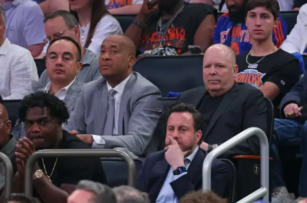 Gersson Rosas, William Wesley, and Leon Rose sitting courtside at a Knicks game.