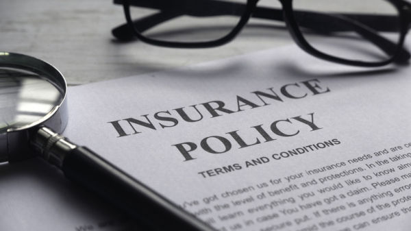 Selective focus on a paper reading out an insurance policy