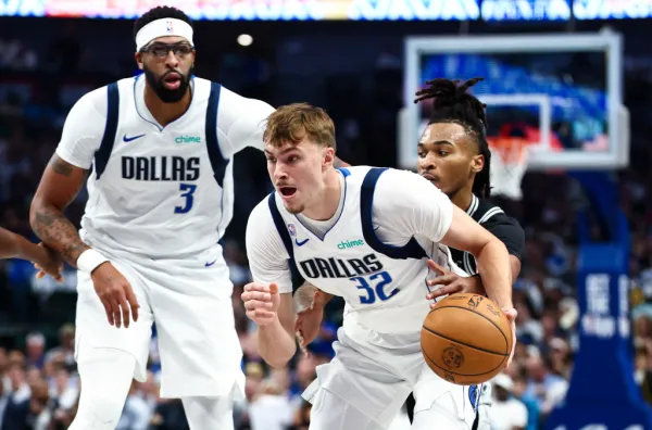 Dallas Mavericks forward Cooper Flagg (32) dribbles as San Antonio Spurs guard Stephon Castle (5) defends during the first quarter at American Airlines Center.