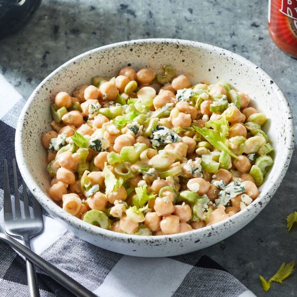 Angled view of a rustic style bowl of Buffalo Chickpea Salad recipe Credit: Photographer: Rachel Marek, Food Stylist: Lauren McAnelly
