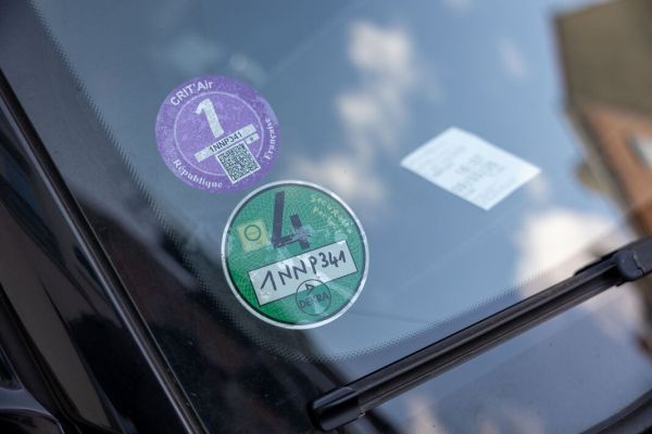 Car windshield displaying crit'air and umweltplakette emission stickers Car windshield displaying crit'air and umweltplakette emission stickers