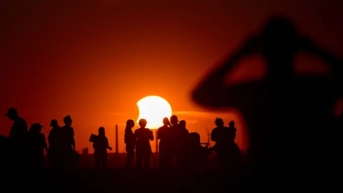 Warga menyaksikan gerhana matahari sebagian di taman lanskap Halde Hoheward di Herten, Jerman bagian barat, Rabu, 12 Agustus 2026.(AFP/Ina Fassbender)