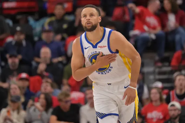 Golden State Warriors guard Stephen Curry heads down court after a three-point basket.