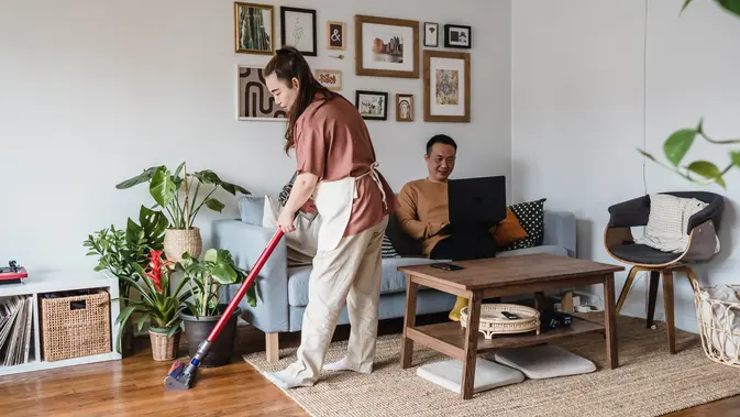 Ilustrasi suami bekerja dan istri membersihkan rumah. (foto: Pexels/Annushka Ahuja)