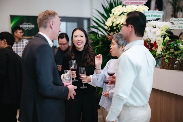Trang Do (C) discussing with guests at the office opening ceremony on Aug. 5. Photo courtesy of the company