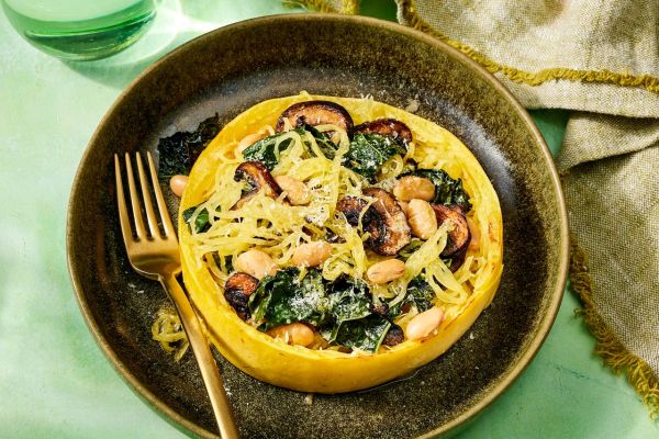 an image of the Spaghetti Squash Nests with Kale, White Beans & Mushrooms Credit: Photographer: Robby Lozano, Food Stylist: Emily Nabors Hall, Prop Stylist: Lydia Pursell
