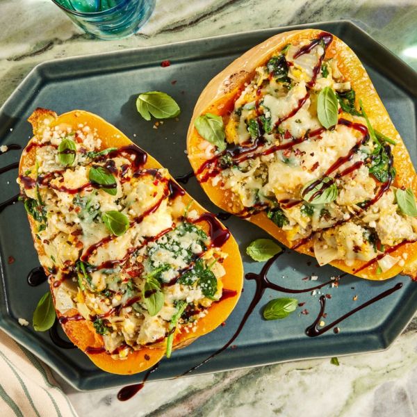 an image of the Cheesy Spinach & Artichoke Stuffed Butternut Squash Credit: Photographer: Jen Causey, Food Stylist: Margaret Monroe Dickey, Prop Stylist: Priscilla Montiel