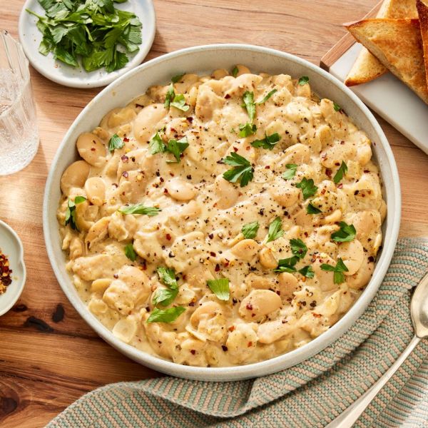an image of the Creamy Garlic-Parmesan Butter Beans Credit: Photographer: Robby Lozano, Food Stylist: Craig Huff, Prop Stylist: Abby Armstrong