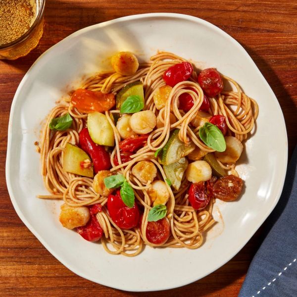 an image of the Garlic-Tomato Bay Scallops Pasta Credit: Photographer: Jen Causey, Food Stylist: Emily Nabors Hall, Prop Stylist: Lindsey Lower