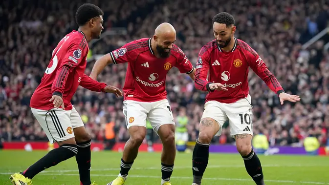 Matheus Cunha (kanan) mengajak Amad Diallo (kiri) dan Bryan Mbeumo (tengan) usai dirinya berhasil mencetak gol perdana Manchester United saat melawan Fulham di Old Trafford, Minggu (1/2/2026) malam WIB. (AP Photo/Dave Thompson)